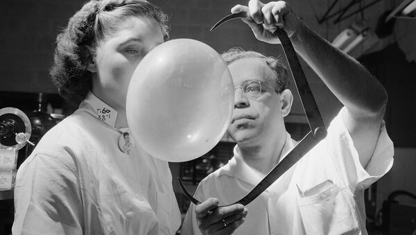 Dr. Morris Nafash, research director for the Bazooka Bubble Gum Company, whose job it was to test the texture and elasticity of the gum and to develop new flavors, is pictured measuring with an outside caliper a bubble blown by Josephine Zack on 16 September 1949 in New York.  Brooklyn-born Dr. Nafash came to his post after 11 years as a researcher at Columbia University's department of chemical engineering.  He blew about 100 bubbles a day and thinks kids probably won't ever blow bubbles much bigger than at present because the kid's face gets in the way.  - Sputnik International