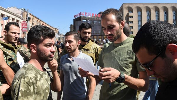 People attend a meeting to recruit military volunteers after Armenian authorities declared martial law and mobilised its male population following clashes with Azerbaijan over the breakaway Nagorno-Karabakh region in Yerevan, Armenia 27 September 2020. - Sputnik International