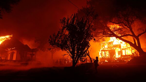 A photographer films a burning property during the Glass Fire in St. Helena, California, U.S. September 27, 2020. - Sputnik International
