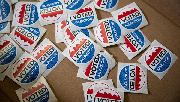 I Voted stickers lie in a box for voters after they place their ballots at an early voting site in Arlington, Virginia, U.S., September 18, 2020. - Sputnik International