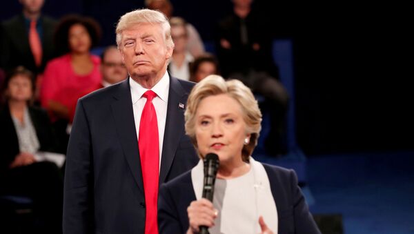 FILE PHOTO: Republican U.S. presidential nominee Donald Trump listens as Democratic nominee Hillary Clinton answers a question from the audience during their presidential town hall debate at Washington University in St. Louis, Missouri, U.S., October 9, 2016 - Sputnik International