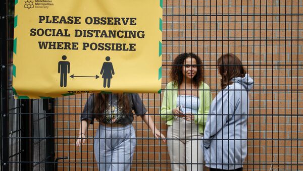 Students who are self-isolating stand in the grounds of their student accommodation, following the outbreak of the coronavirus disease (COVID-19) in Manchester, Britain, September 28, 2020 - Sputnik International