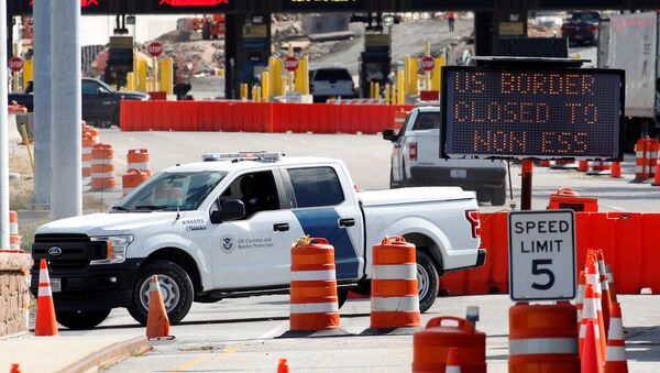 A U.S. Customs and Protection vehicle stands beside a sign reading that the border is closed to non-essential traffic at the Canada-United States border crossing at the Thousand Islands Bridge, to combat the spread of the coronavirus disease (COVID-19) in Lansdowne, Ontario, Canada September 28, 2020. - Sputnik International