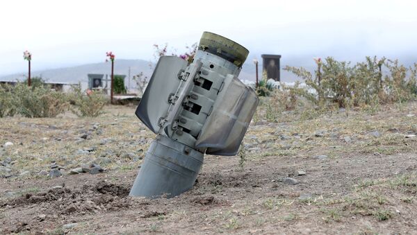  The remains of a rocket shell are seen near a graveyard in the town of Ivanyan (Khojaly) in the breakaway region of Nagorno-Karabakh, October 1, 2020 - Sputnik International