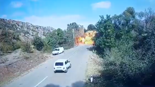 Screenshot of video showing alleged Azerbaijani attack on bridge connecting Armenia proper to the breakaway region of Nagorno-Karabakh. - Sputnik International