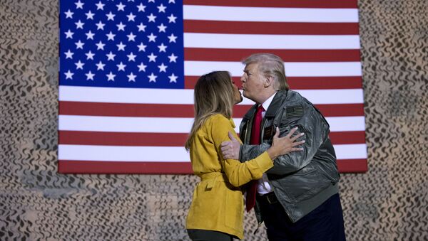 President Donald Trump kisses first lady Melania Trump during a hangar rally at Al Asad Air Base, Iraq, Wednesday, Dec. 26, 2018. President Donald Trump, who is visiting Iraq, says he has 'no plans at all' to remove U.S. troops from the country - Sputnik International