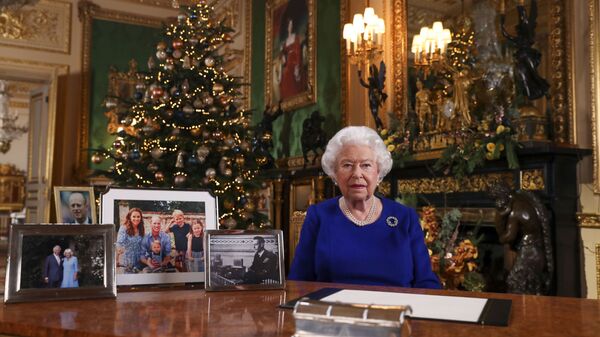 In this image released Tuesday 24 Dec, 2019, Britain's Queen Elizabeth II poses for a photo, while recording her annual Christmas Day message to the nation, at Windsor Castle, England - Sputnik International