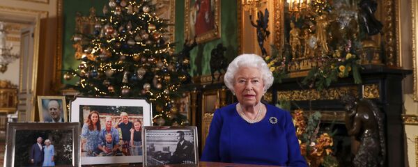 In this image released Tuesday 24 Dec, 2019, Britain's Queen Elizabeth II poses for a photo, while recording her annual Christmas Day message to the nation, at Windsor Castle, England - Sputnik International