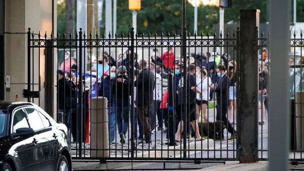 A crowd of members of the public gathers outside the gates of Walter Reed National Military Medical Center as the Marine One helicopter with U.S. President Donald Trump aboard  - Sputnik International