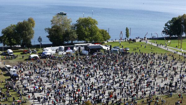 A general view taken from a wheel shows people gathering during a protest against the government's restrictions, amid the coronavirus disease (COVID-19) outbreak, in Konstanz, Germany October 4, 2020 - Sputnik International