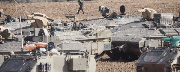 An Israeli soldier walks past military vehicles in a gathering point near the Israel-Gaza Border, Thursday, Nov. 14, 2019 An Israeli soldier walks past military vehicles in a gathering point near the Israel-Gaza Border, Thursday, Nov. 14, 2019 - Sputnik International
