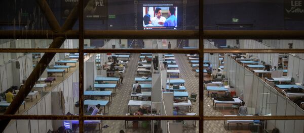 Patients watch a movie on a big screen at a makeshift COVID-19 care center set up in an indoor sports stadium, in New Delhi, India, Saturday, Sept. 19, 2020 Patients watch a movie on a big screen at a makeshift COVID-19 care center set up in an indoor sports stadium, in New Delhi, India, Saturday, Sept. 19, 2020 - Sputnik International
