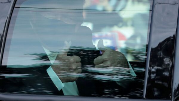 FILE PHOTO: FILE PHOTO: US President Donald Trump gestures from a car as he rides in front of the Walter Reed National Military Medical Center, where he is being treated for the coronavirus disease (COVID-19) in Bethesda, Maryland, US.October 4, 2020 - Sputnik International
