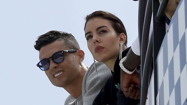  In this May 23, 2019, file photo, Cristiano Ronaldo, left, is flanked by his partner Georgina Rodriguez as they watch the second practice session for a Formula One race at the Monaco racetrack, in Monaco - Sputnik International