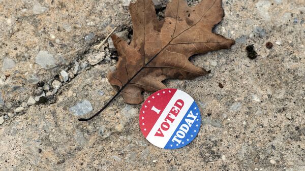 A discarded voting sticker lies on the ground at a satellite election office at Overbrook High School on Thursday, Oct. 1, 2020, in Philadelphia. The city of Philadelphia has opened several satellite election offices and more are slated to open in the coming weeks where voters can drop off their mail in ballots before Election Day.  - Sputnik International