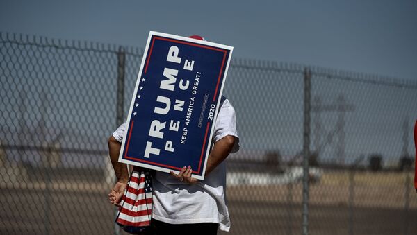 A woman holds a Trump Pence sign as she waits in line to attend the Great American Comeback Event campaign rally with US President Donald Trump at Xtreme Manufacturing in Henderson, Nevada on September 13, 2020 - Sputnik International