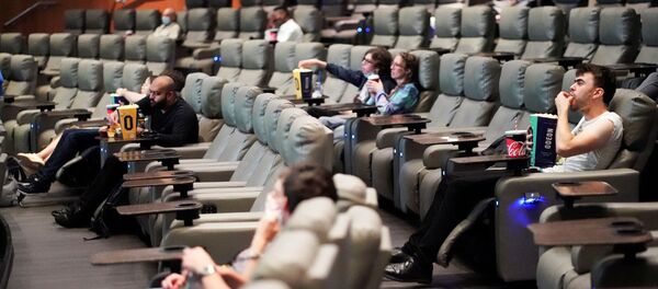  People take their seats inside the Odeon Luxe Leicester Square cinema, on the opening day of the film Tenet, amid the coronavirus disease (COVID-19) outbreak, in London, Britain, August 26, 2020 - Sputnik International