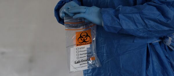 A biohazard bag is used for containing a specimen for a coronavirus disease (COVID-19) test - Sputnik International