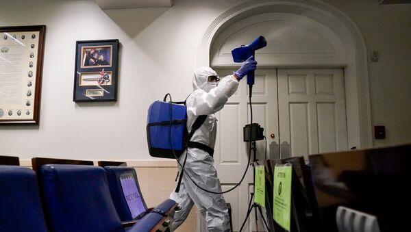 A member of the White House cleaning staff sprays the press briefing room the evening of U.S. President Donald Trump's return from Walter Reed Medical Center after contracting the coronavirus disease (COVID-19), in Washington, U.S., October 5, 2020. - Sputnik International