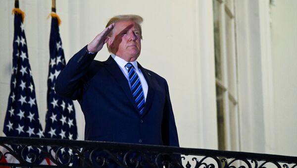 U.S. President Donald Trump salutes as he poses without a face mask on the Truman Balcony of the White House after returning from being hospitalized at Walter Reed Medical Center for coronavirus disease (COVID-19) treatment, in Washington, U.S. October 5, 2020. - Sputnik International