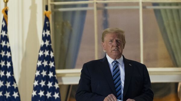 President Donald Trump removes his mask as he stands on the Blue Room Balcony upon returning to the White House on Monday, 5 October 2020, in Washington, after leaving Walter Reed National Military Medical Center, in Bethesda, MD. Trump announced he'd tested positive for COVID-19 on 2 October. - Sputnik International