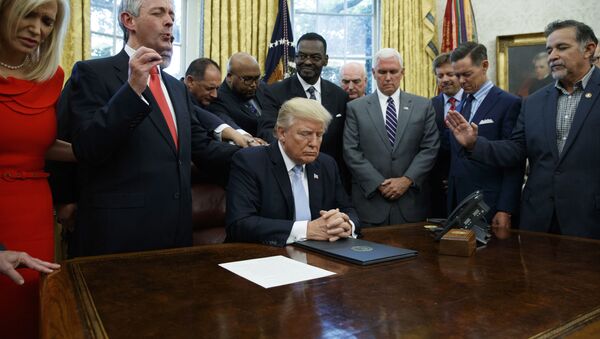 In this Sept. 1, 2017 file photo, religious leaders pray with President Donald Trump after he signed a proclamation for a national day of prayer to occur on Sunday, Sept. 3, 2017, in the Oval Office of the White House in Washington. - Sputnik International