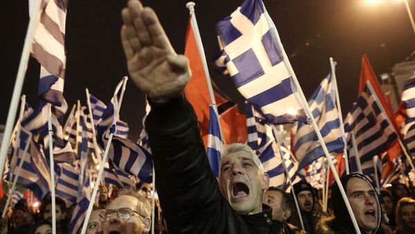 A supporter of Greece's Golden Dawn makes a Nazi-style salute in 2014 - Sputnik International