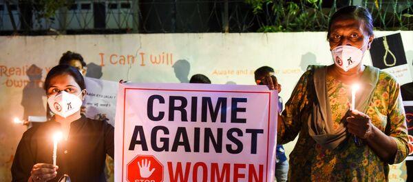 Lawyers display a placard to condemn the alleged gang-rape and murder of a low-caste teenaged woman in Uttar Pradesh state during a candlelight vigil in Ahmedabad on October 6, 2020. Lawyers display a placard to condemn the alleged gang-rape and murder of a low-caste teenaged woman in Uttar Pradesh state during a candlelight vigil in Ahmedabad on October 6, 2020. - Sputnik International