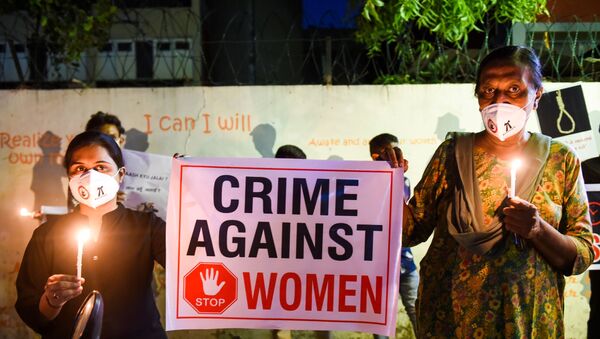 Lawyers display a placard to condemn the alleged gang-rape and murder of a low-caste teenaged woman in Uttar Pradesh state during a candlelight vigil in Ahmedabad on October 6, 2020. - Sputnik International