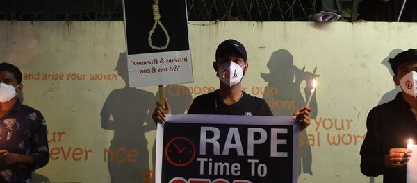Protesters display placards to condemn the alleged gang-rape and murder of a low-caste teenaged woman in Uttar Pradesh state during a candlelight vigil in Ahmedabad on October 6, 2020.  - Sputnik International