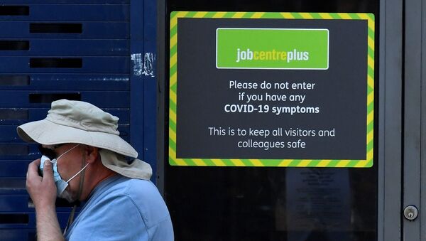 A person wearing a protective face mask walks past a Job Centre Plus office, amidst the outbreak of the coronavirus disease (COVID-19) in London, Britain, August 11, 2020. - Sputnik International