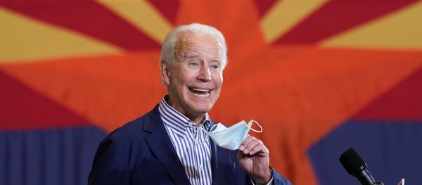 U.S. Democratic presidential candidate Joe Biden holds a face mask while speaking at a carpenters union in Phoenix, Arizona, U.S., October 8, 2020 U.S. Democratic presidential candidate Joe Biden holds a face mask while speaking at a carpenters union in Phoenix, Arizona, U.S., October 8, 2020 - Sputnik International