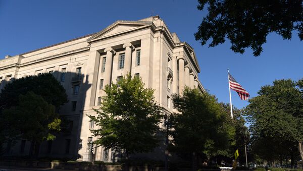The American flag flies outside of the Justice Department building, Thursday, Oct. 8, 2020, in Washington - Sputnik International