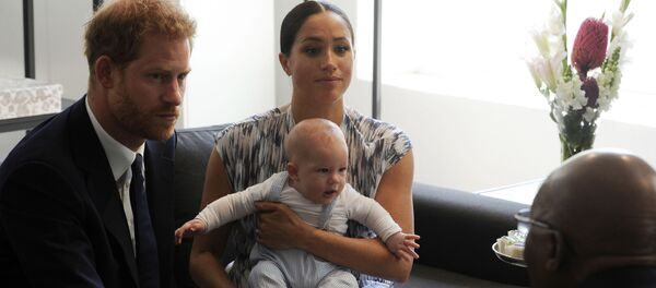 Britain's Prince Harry and Meghan, Duchess of Sussex, holding their son Archie, meet with Anglican Archbishop Emeritus, Desmond Tutu in Cape Town, South Africa, Wednesday Sept. 25, 2019. - Sputnik International