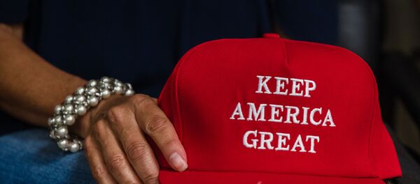 Deborah Palomba holds a Keep America Great hat as she watches US President Donald Trump acceptance speech for the Republican Party nomination for reelection during the final day of the Republican National Convention on TV in the office of San Diego County's Republican Party in Rancho Bernardo, California on August 27, 2020 Deborah Palomba holds a Keep America Great hat as she watches US President Donald Trump acceptance speech for the Republican Party nomination for reelection during the final day of the Republican National Convention on TV in the office of San Diego County's Republican Party in Rancho Bernardo, California on August 27, 2020 - Sputnik International