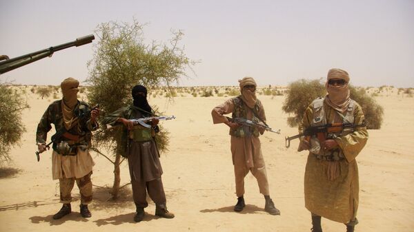 In this Tuesday, April 24, 2012 file photo, fighters from Islamist group Ansar Dine stand guard during a hostage handover, in the desert outside Timbuktu, Mali.   - Sputnik International