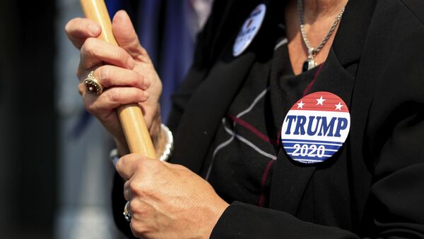 A view of a Trump button worn by a supporter, at the Hamilton County Board of Elections as people arrive to participate in early voting, Tuesday, Oct. 6, 2020, in Norwood, Ohio - Sputnik International