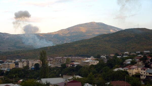 Smoke rises after an artillery strike in Stepanakert, Nagorno-Karabakh - Sputnik International