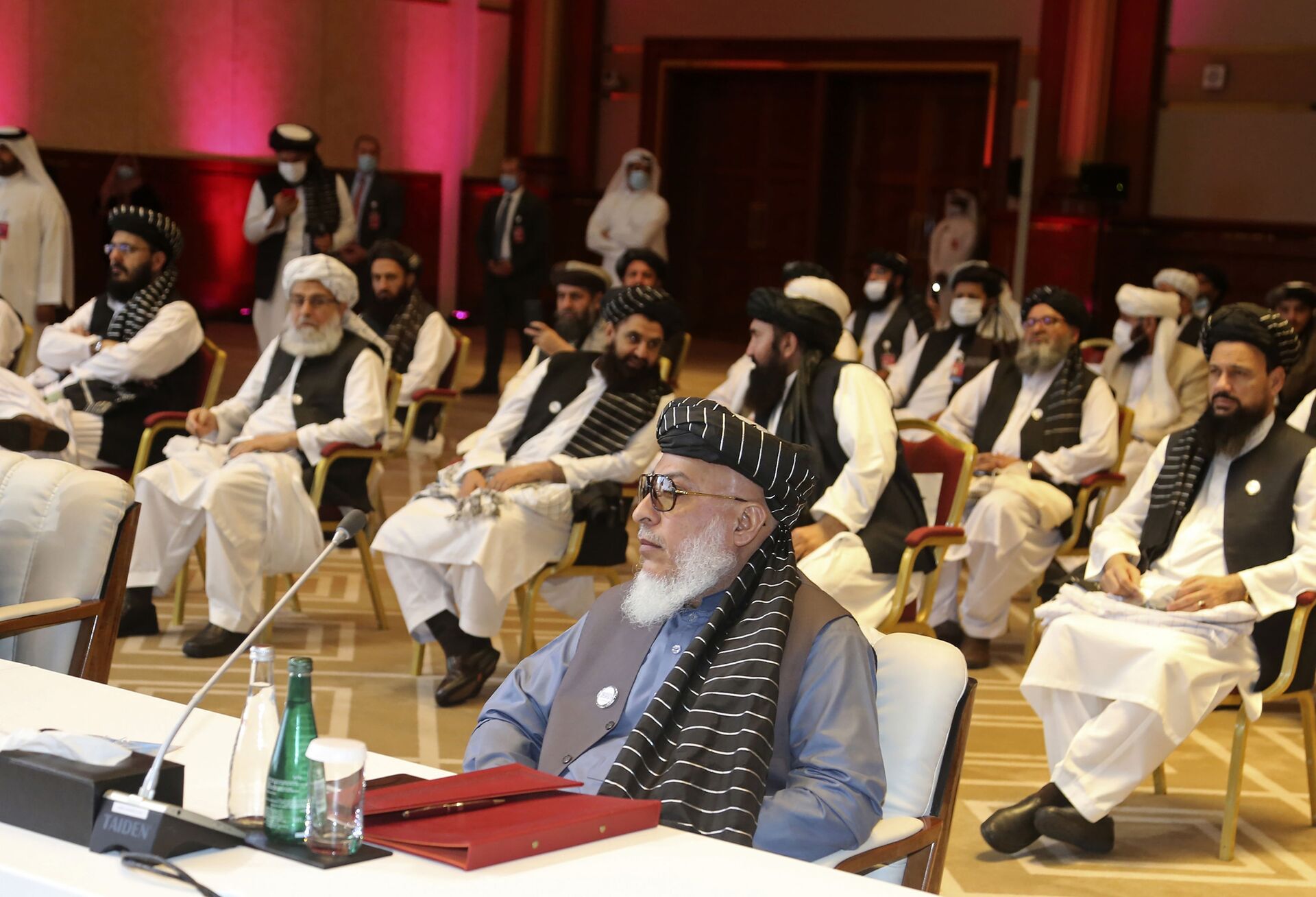 In this Sept. 12, 2020, file photo, Taliban negotiator Abbas Stanikzai, center front, and his delegation attend the opening session of peace talks between the Afghan government and the Taliban, in Doha, Qatar. Afghanistan’s Taliban on Thursday, Oct. 8, 2020, welcomed a tweet from President Donald Trump in which he promised to have the last of the U.S.'s troops out of Afghanistan by Christmas. If that withdrawal happens, it would be months ahead of schedule and the tweet made no reference to a Taliban promise to fight terrorist groups — a previous pre-requisite for an American withdrawal. - Sputnik International, 1920, 07.09.2021