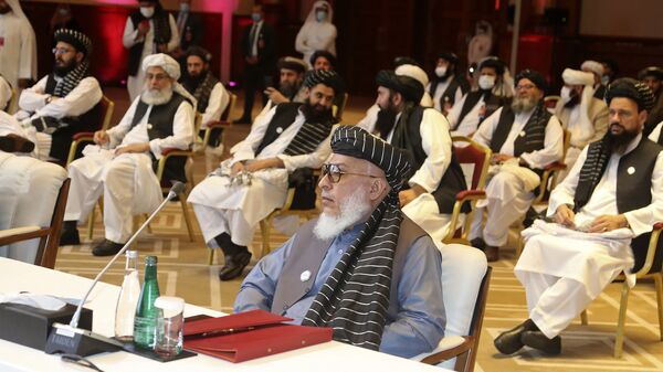 In this Sept. 12, 2020, file photo, Taliban negotiator Abbas Stanikzai, center front, and his delegation attend the opening session of peace talks between the Afghan government and the Taliban, in Doha, Qatar. Afghanistan’s Taliban on Thursday, Oct. 8, 2020, welcomed a tweet from President Donald Trump in which he promised to have the last of the U.S.'s troops out of Afghanistan by Christmas. If that withdrawal happens, it would be months ahead of schedule and the tweet made no reference to a Taliban promise to fight terrorist groups — a previous pre-requisite for an American withdrawal. - Sputnik International