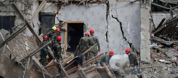 Search and rescue teams work on the blast site hit by a rocket during the fighting over the breakaway region of Nagorno-Karabakh in the city of Ganja, Azerbaijan October 11, 2020. Search and rescue teams work on the blast site hit by a rocket during the fighting over the breakaway region of Nagorno-Karabakh in the city of Ganja, Azerbaijan October 11, 2020. - Sputnik International