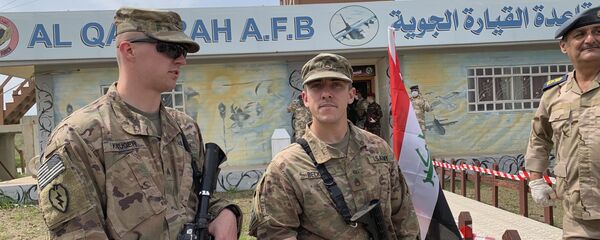 U.S. soldiers stand guard during the hand over ceremony of Qayyarah Airfield, Iraqi Security Forces, in the south of Mosul, Iraq early Friday, March 27, 2020. Iraq's military on Thursday said at least two rockets hit inside Baghdad's heavily fortified Green Zone, the seat of Iraq's government and home to the American Embassy, in the first attack following a brief lull in violence from earlier this month. U.S. soldiers stand guard during the hand over ceremony of Qayyarah Airfield, Iraqi Security Forces, in the south of Mosul, Iraq early Friday, March 27, 2020. Iraq's military on Thursday said at least two rockets hit inside Baghdad's heavily fortified Green Zone, the seat of Iraq's government and home to the American Embassy, in the first attack following a brief lull in violence from earlier this month. - Sputnik International