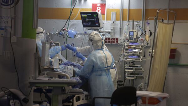 Medical professionals in full protective equipment tend to an elderly man on a ventilator in the critical care coronavirus unit, which was built in an underground parking garage at Sheba Medical center in Ramat Gan, Israel, Wednesday, Sept. 30, 2020, amid a spike in COVID-19 cases. - Sputnik International