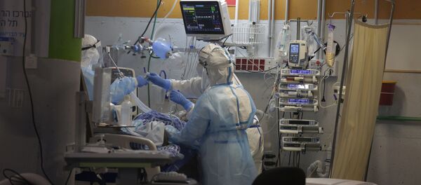 Medical professionals in full protective equipment tend to an elderly man on a ventilator in the critical care coronavirus unit, which was built in an underground parking garage at Sheba Medical center in Ramat Gan, Israel, Wednesday, Sept. 30, 2020, amid a spike in COVID-19 cases. - Sputnik International