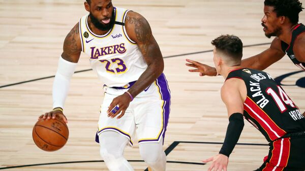 Oct 11, 2020; Lake Buena Vista, Florida, USA; Los Angeles Lakers forward LeBron James (23) dribbles while defended by Miami Heat guard Tyler Herro (14) during the first quarter in game six of the 2020 NBA Finals at AdventHealth Arena.  - Sputnik International