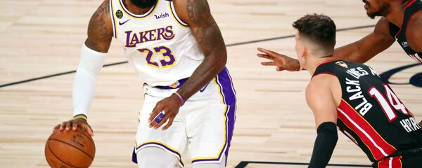 Oct 11, 2020; Lake Buena Vista, Florida, USA; Los Angeles Lakers forward LeBron James (23) dribbles while defended by Miami Heat guard Tyler Herro (14) during the first quarter in game six of the 2020 NBA Finals at AdventHealth Arena.  - Sputnik International