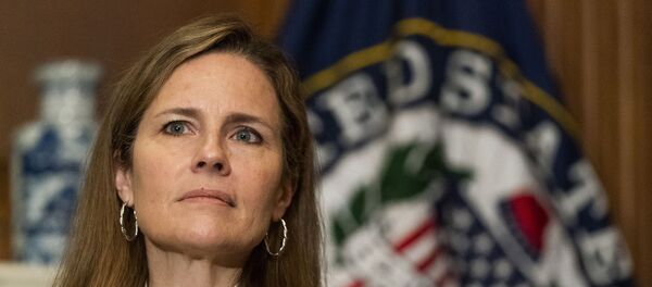 In this 1 October 2020, file photo, President Donald Trump's Supreme Court nominee Judge Amy Coney Barrett listens as Sen. Jerry Moran, R-Kan., not shown, speaks during their meeting on Capitol Hill in Washington In this 1 October 2020, file photo, President Donald Trump's Supreme Court nominee Judge Amy Coney Barrett listens as Sen. Jerry Moran, R-Kan., not shown, speaks during their meeting on Capitol Hill in Washington - Sputnik International