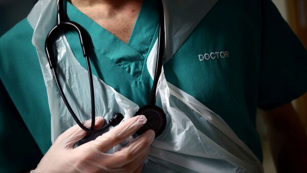 FILE PHOTO: A Junior Doctor holds his stethoscope during a patient visit on Ward C22 at The Royal Blackburn Teaching Hospital in East Lancashire, following the outbreak of the coronavirus disease (COVID-19), in Blackburn, Britain, May 14, 2020 - Sputnik International