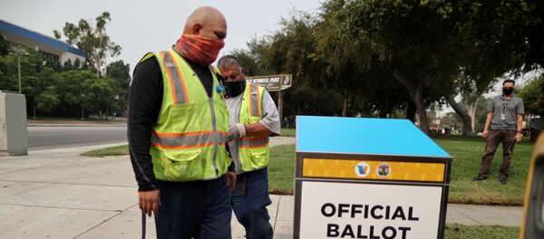 StreetsLA workers install one of 123 Vote by Mail Drop Boxes outside a public library, amid the global outbreak of the coronavirus disease (COVID-19), in Los Angeles, California, U.S., September 11, 2020. - Sputnik International
