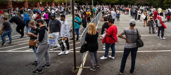 Hundreds of people wait in line for early voting on Monday, Oct. 12, 2020, in Marietta, Georgia - Sputnik International